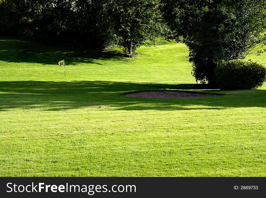 Golf field with yellow flag. Golf field with yellow flag.