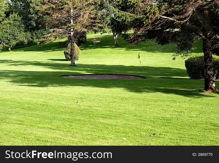 Golf field with yellow flag. Golf field with yellow flag.