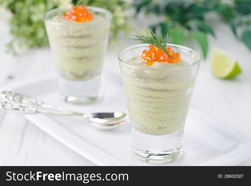 Avocado mousse with caviar and lime portions garnished with a sprig of dill