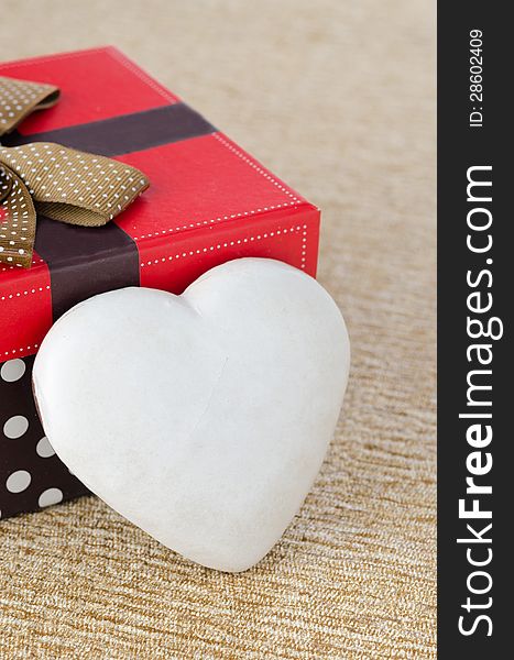 Cookie with icing in the form of heart near the gift box, top view. Cookie with icing in the form of heart near the gift box, top view