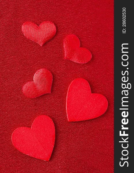 Hearts of different sizes on a red background  for Valentine's Day, closeup. Hearts of different sizes on a red background  for Valentine's Day, closeup