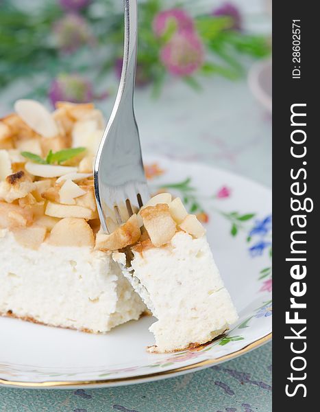 Piece of cottage cheese with apple pie with a fork
