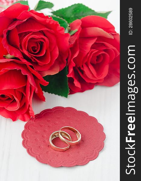 Red roses and rings for Valentine's Day vertical. Red roses and rings for Valentine's Day vertical