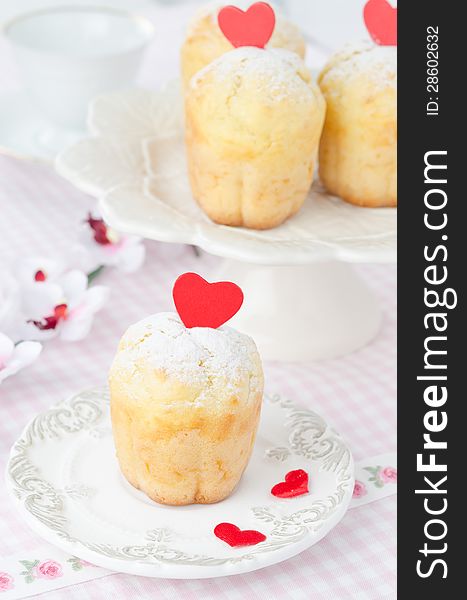 Rum Baba decorated with red hearts on a plate and a few in the b