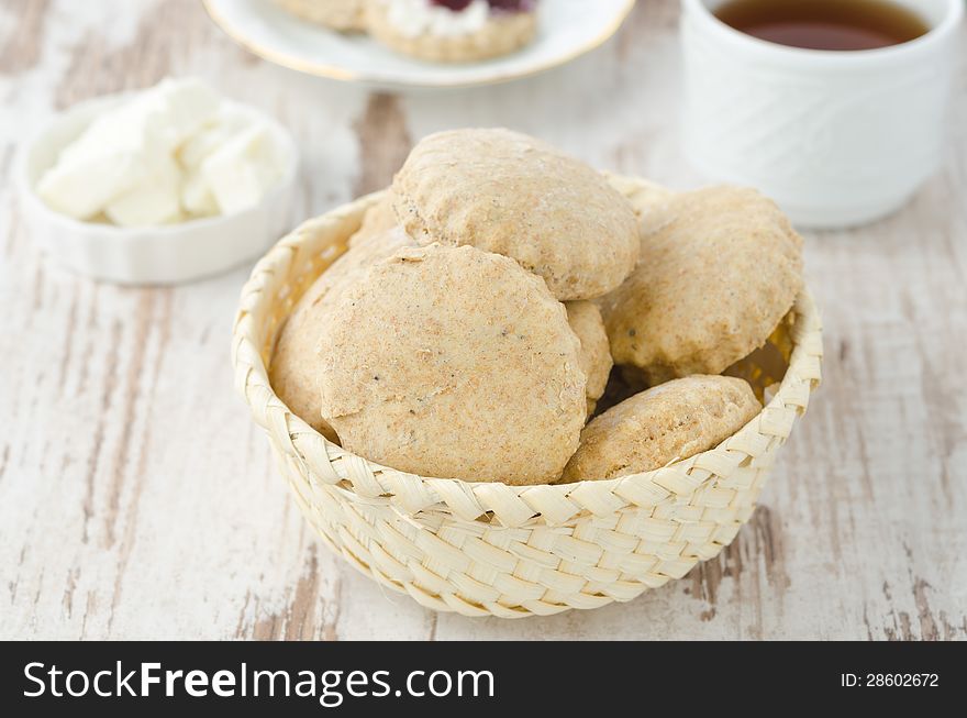 Scone of whole wheat in a wicker basket for breakfast horizontal. Scone of whole wheat in a wicker basket for breakfast horizontal