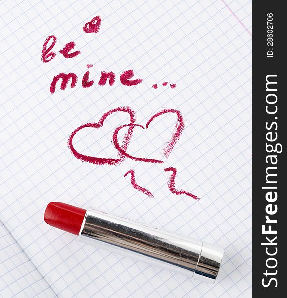 Sign on heart in a notebook and red lipstick in Valentine&#x27;s Day