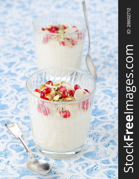 Semolina dessert with pomegranate seeds and pistachios in a glas