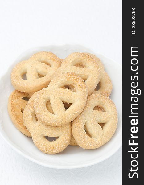 Sugar cookies in a white bowl, top view