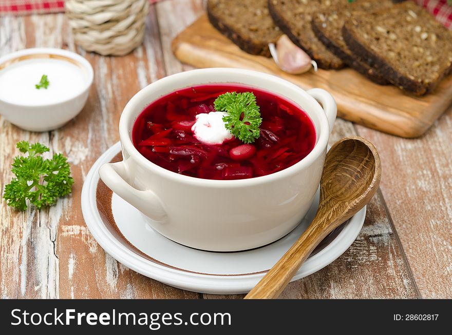 Ukrainian and russian national red borsch with sour cream on the table horizontal. Ukrainian and russian national red borsch with sour cream on the table horizontal