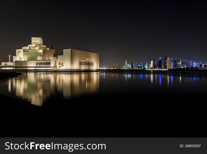 Night shot of the Museum of Islamic Art with reflection and the Doha skyline in the background. Night shot of the Museum of Islamic Art with reflection and the Doha skyline in the background.