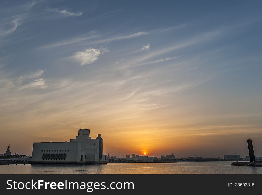 Museum of Islamic Art in Doha agains the setting sun with the'seven' monument' to the right. Museum of Islamic Art in Doha agains the setting sun with the'seven' monument' to the right.