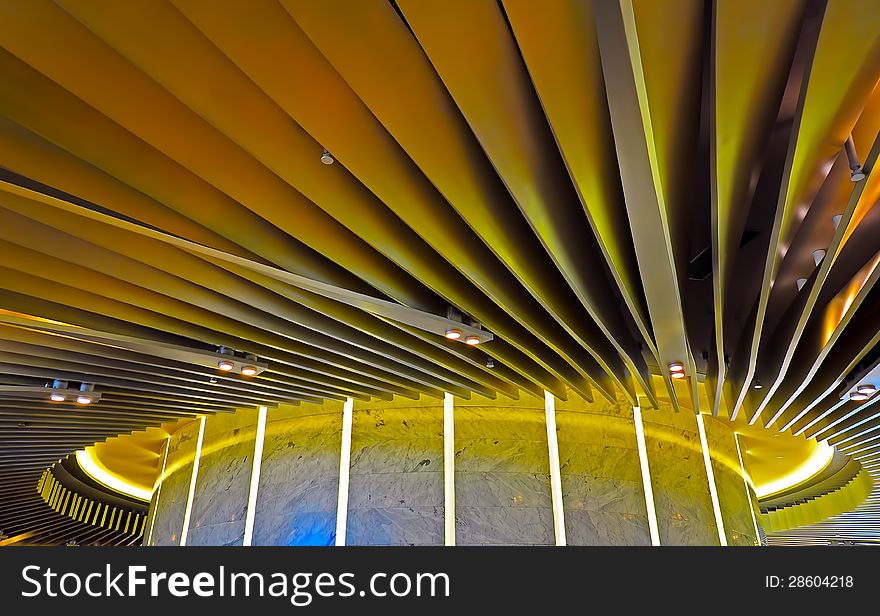 Ceiling graphic design of a modern building illuminated with yellow lighting. Ceiling graphic design of a modern building illuminated with yellow lighting