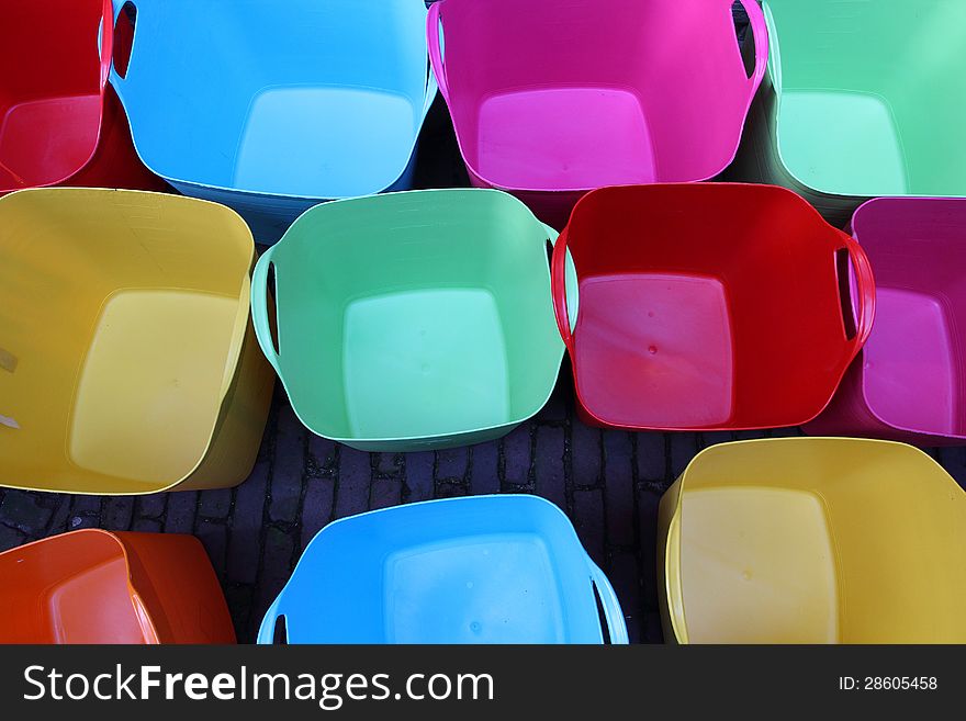 Set of colorful plastic baskets in yellow, pink, red, green and blue