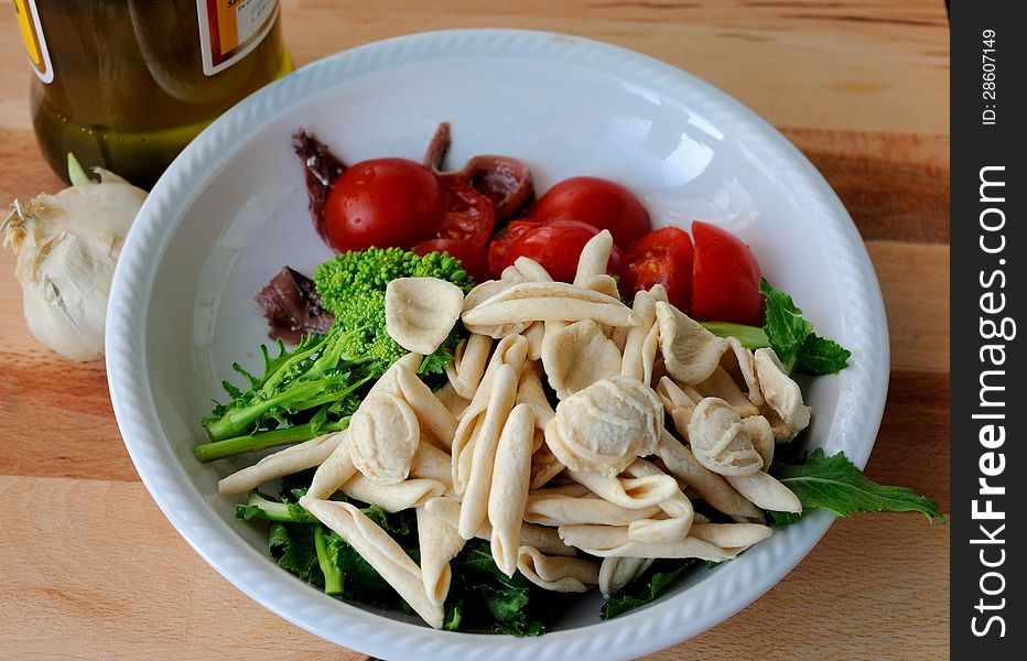 Italian Cuisine - preparation of orecchiette and turnip greens. Italian Cuisine - preparation of orecchiette and turnip greens