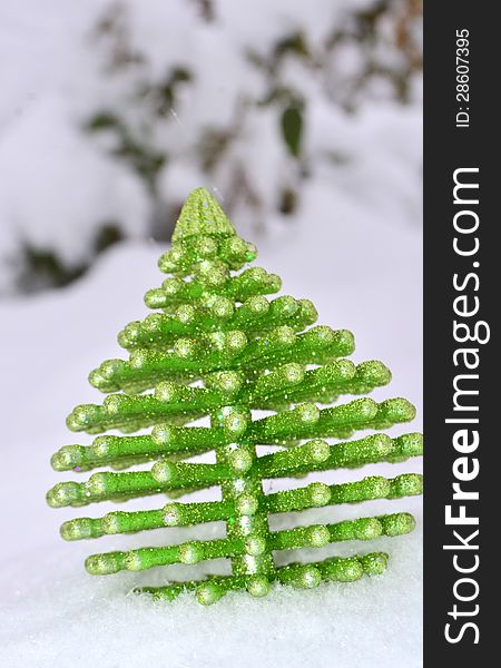 Image of a Christmas tree ornament on snow