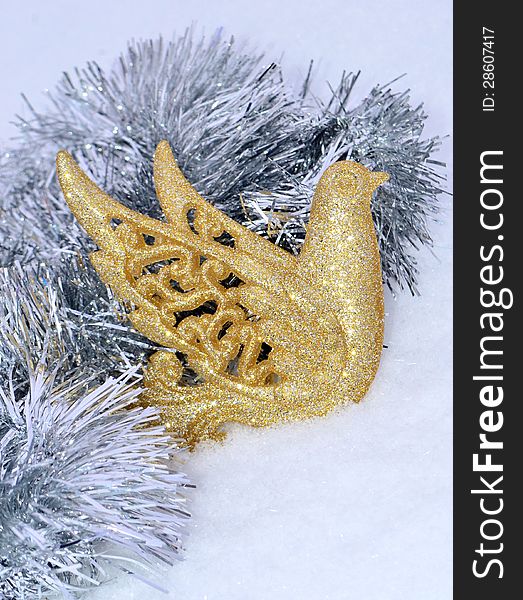 Image of a Christmas ornament on tinsel on snow