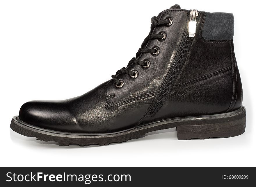 Classical black leather mans ankle high laceup boot for everyday formal wear on a white studio background. Classical black leather mans ankle high laceup boot for everyday formal wear on a white studio background