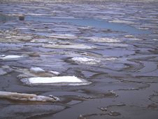 Dark Water Coming Through Shattern Ice Stock Photos