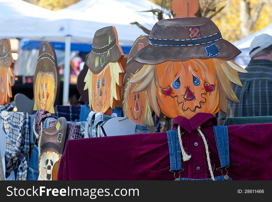 Colorful Wooden Scarecrow Stands On Display.