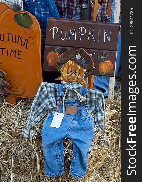 Colorful Wooden Scarecrow Stands On Display.