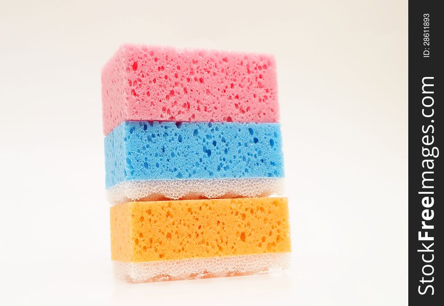 Pink, blue and orange sponge, towards white background