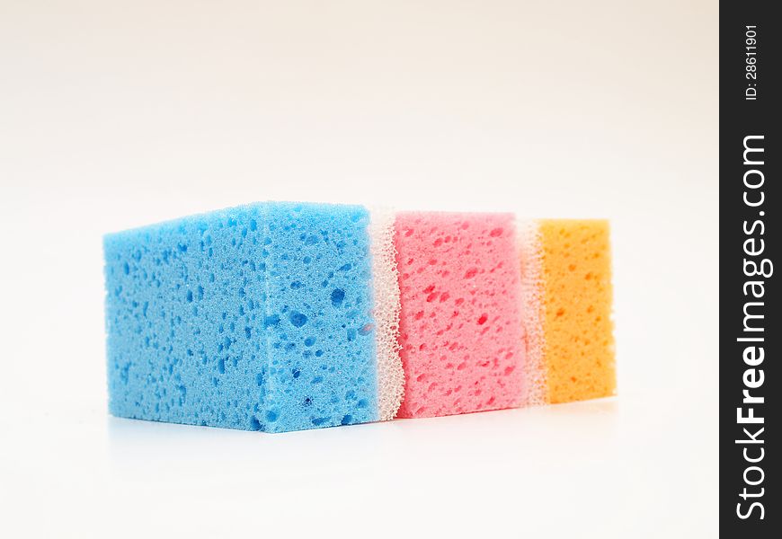 Pink, blue and orange sponge, towards white background