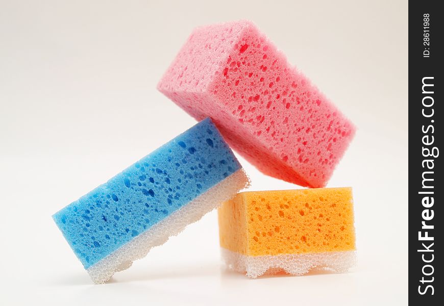 Pink, blue and orange sponge, towards white background
