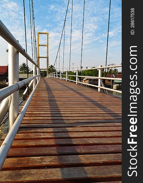 Wooden way on cable bridge with blue sky and cloudy
