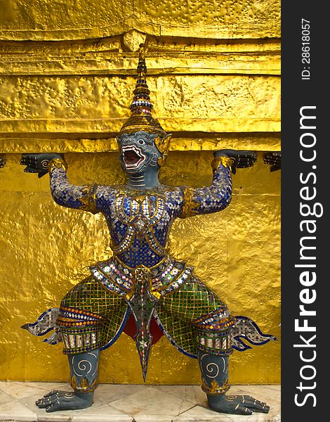 Dark blue Ramayana monkey shoulder the golden pagoda at wat Phra Kaew, Bangkok, Thailand