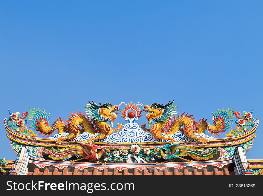 Twin Chinese dragon on the temple roof with blusky