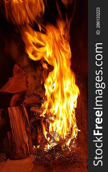 background bonfire from branches in the fireplace . flame sparks of fire on a black background burning bonfires on a dark background