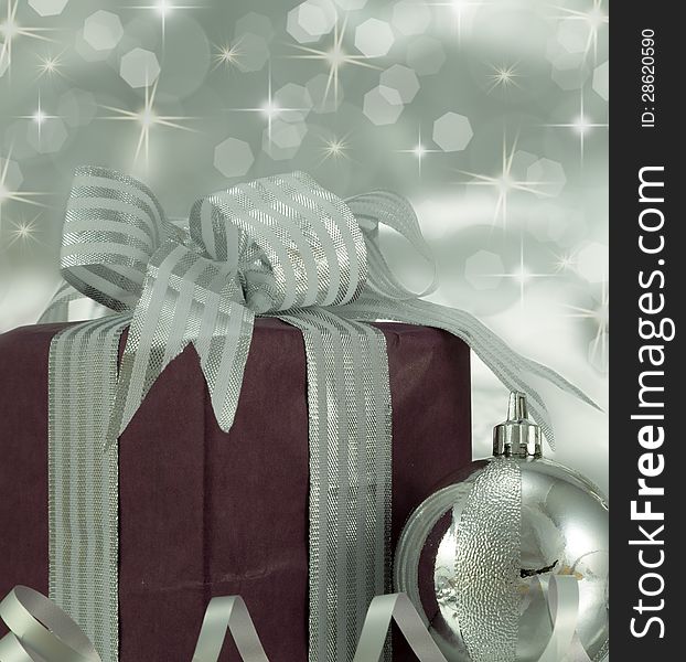 Beautifully wrapped present with silver bauble. Beautifully wrapped present with silver bauble.