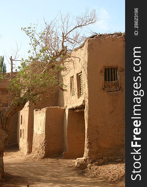 Mud constructed town in a Taklamakan desert oasis, Xinjiang, western China. The site was along the ancient northern silk road. Mud constructed town in a Taklamakan desert oasis, Xinjiang, western China. The site was along the ancient northern silk road