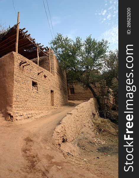 Mud constructed town in a Taklamakan desert oasis, Xinjiang, western China. The site was along the ancient northern silk road. Mud constructed town in a Taklamakan desert oasis, Xinjiang, western China. The site was along the ancient northern silk road