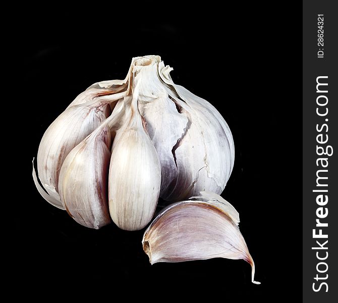 Ripe garlic isolated over black background. Ripe garlic isolated over black background