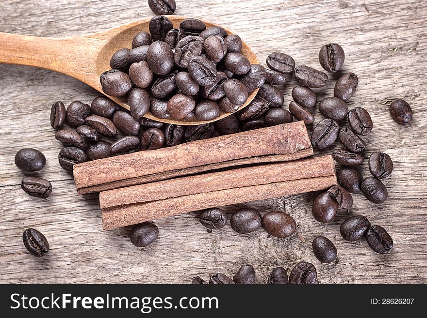 Ingredients of coffee beans and cinnamon in wooden spoon. Ingredients of coffee beans and cinnamon in wooden spoon