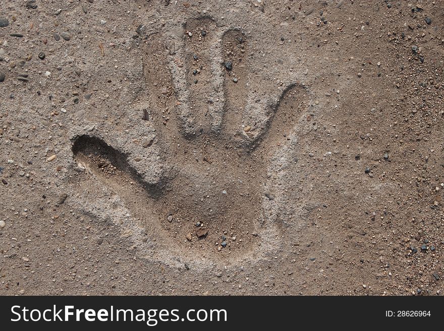 Imprint of a childs hand in cement