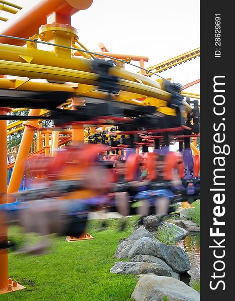 Rollercoasters at amusement park with riders. Rollercoasters at amusement park with riders