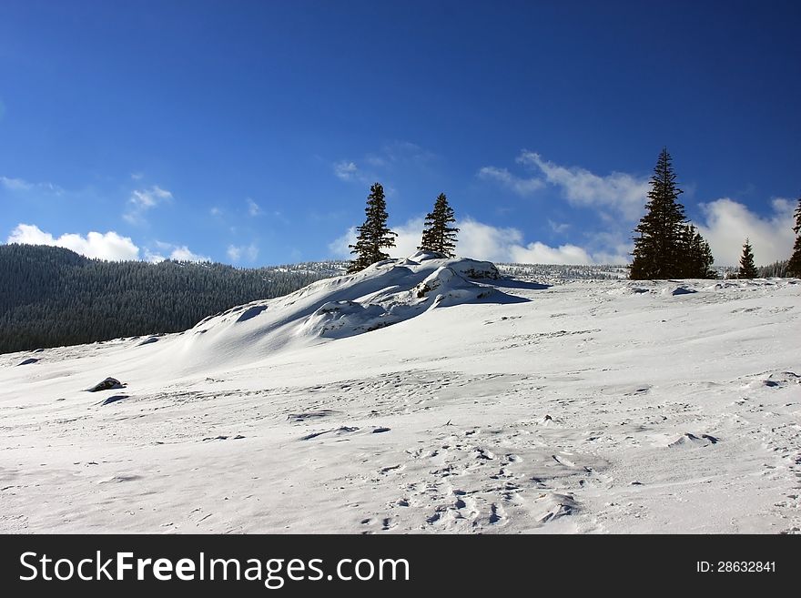 This image presents a beautiful winter landscape with sky tracks.