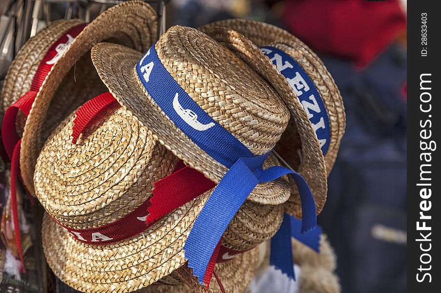 Traditional straws gondolier's hats on a stand of souvenirs in Venice. Traditional straws gondolier's hats on a stand of souvenirs in Venice.