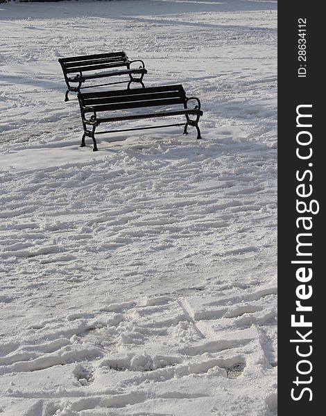 Two empty benches in the snow. Two empty benches in the snow