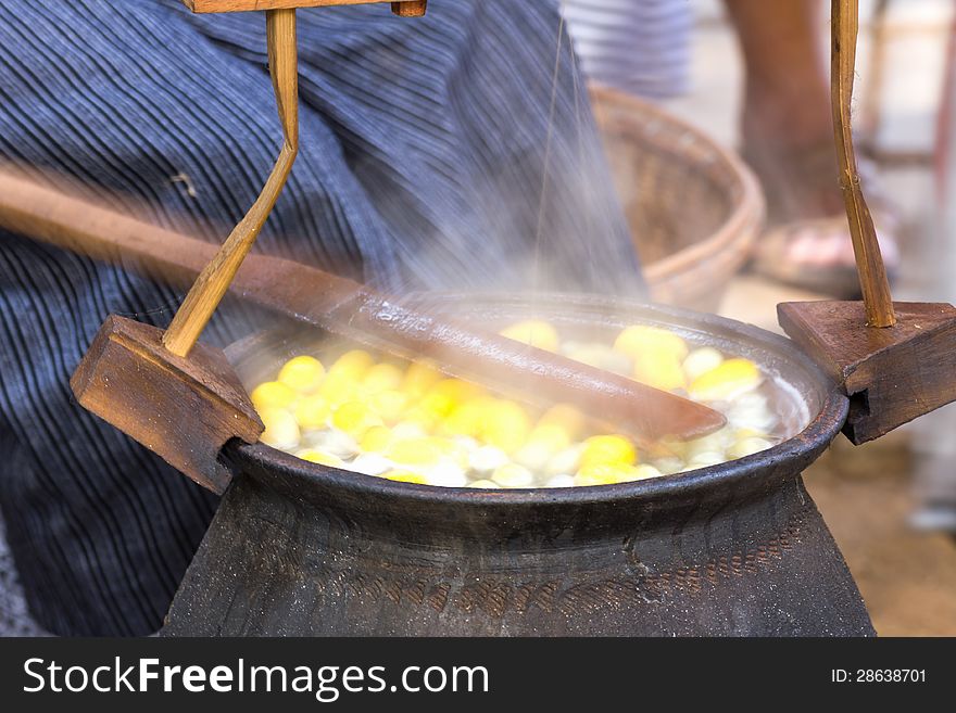 Boiling cocoon in a pot to prepare a cocoon silk.