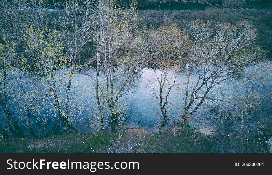 Drone shot of a river through the woods