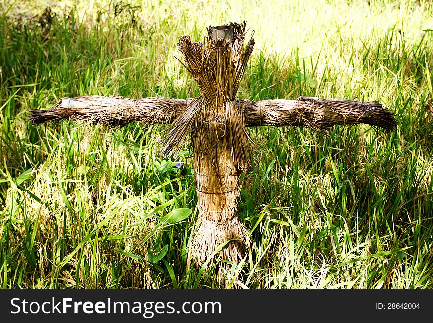 Scarecrow in a grass, made from a straw