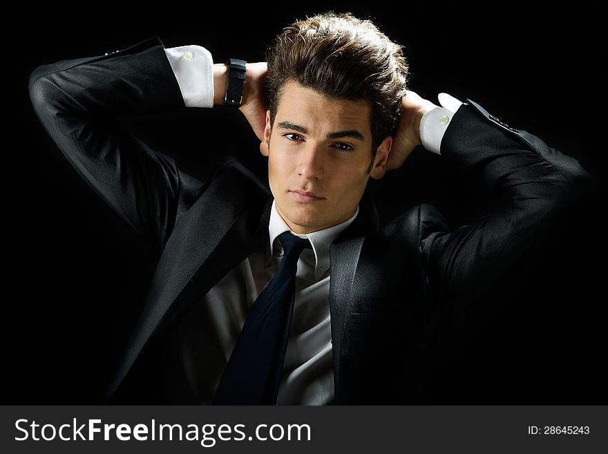 Young businessman, isolated on black background