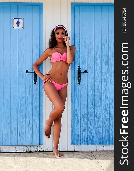 Woman with beautiful body in a beach hut