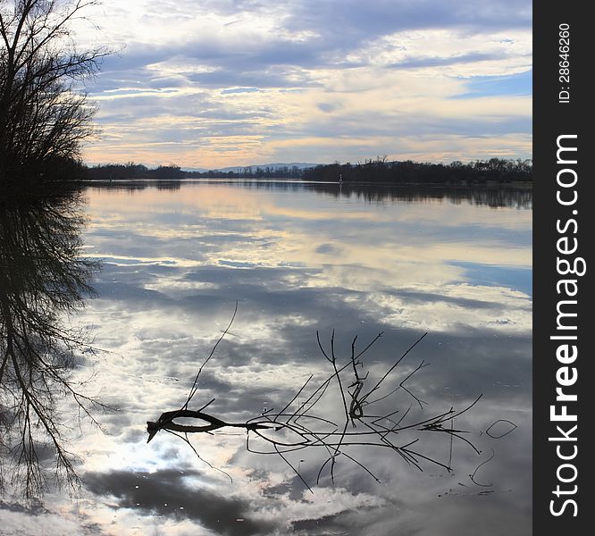 Sky, clouds and darkness reflecting in the river. Sky, clouds and darkness reflecting in the river