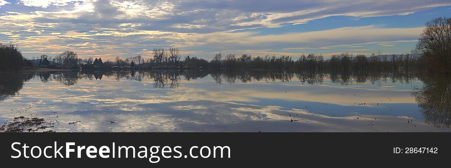 Panoramic view of sky, clouds and darkness reflecting in the  river. Panoramic view of sky, clouds and darkness reflecting in the  river