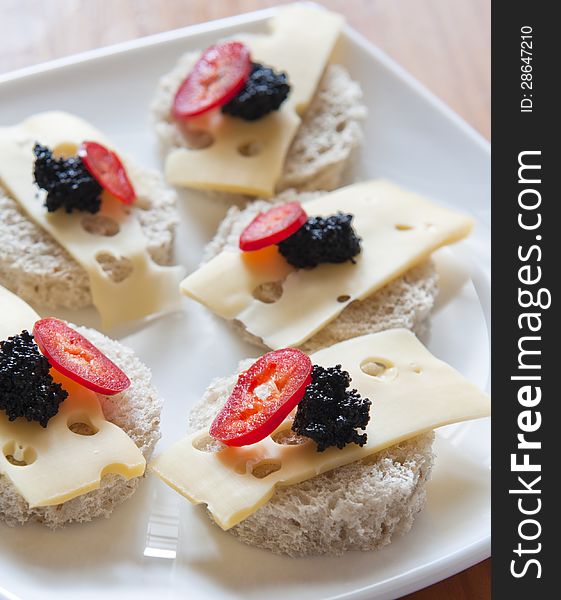 Caviar and cheese served as appetizer at parties