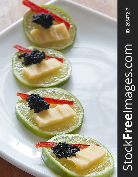 Lime, cheese and caviar served as party snacks